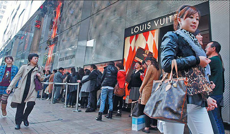 SHANGHAI, CHINA - JUNE 28, 2023 - People take photos of Louis Vuitton coffee  they just bought at the entrance of a Louis Vuitton cafe in Shanghai,  China, June 28, 2023. Recently