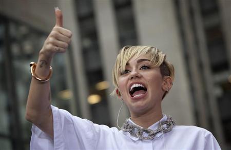 Miley Cyrus grabs top slot in UK single and album charts