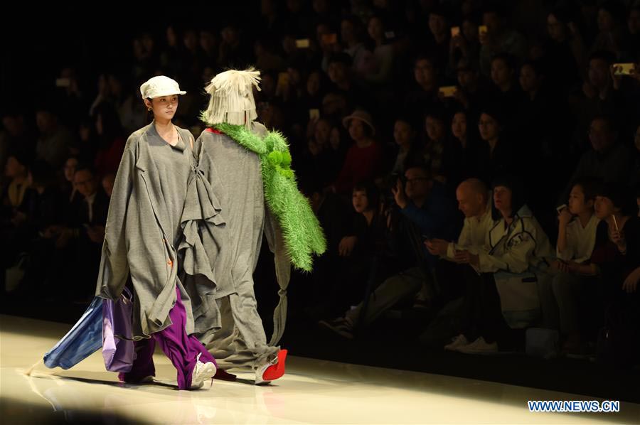 Models present fashion designs of graduates in Beijing