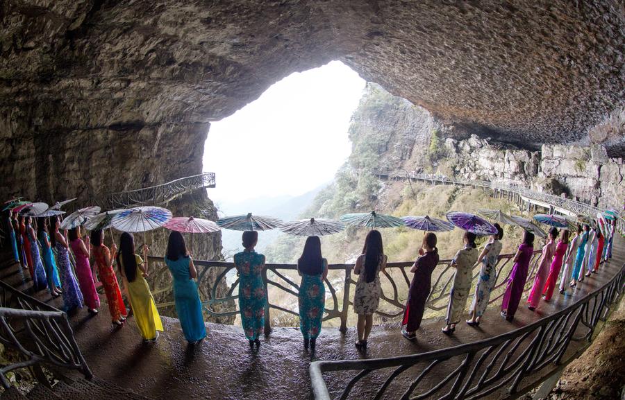 Qipao show presented on plank road built along vertical cliff in SW China