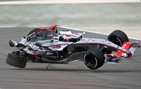 The McLaren Formula One car driven by Kimi Raikkonen of Finland bounces off the track after a suspension and rear wing failure at high speed during the qualifying session for the Bahrain Formula One Grand Prix at the Sakhir racetrack in Manama March 11, 2006. 