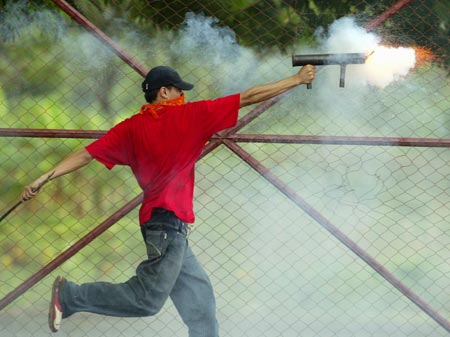A student fires a homemade mortar at riot police during a protest, which started four weeks ago, against a fee increase in public transportation in Managua, Nicaragua June 7, 2006.