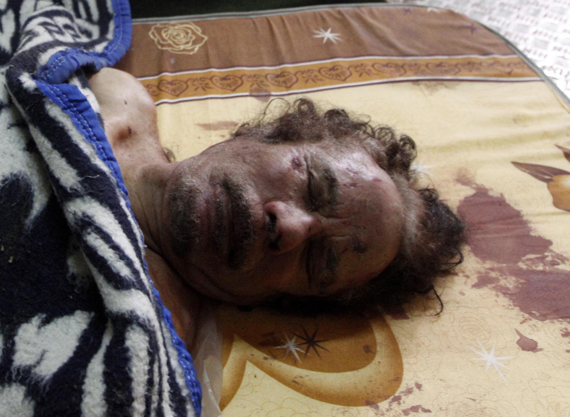 卡扎菲遗体被放肉铺冷藏室 利比亚或8个月内举行大选