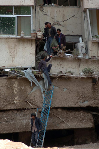 Frantic search for signs of life after landslide
