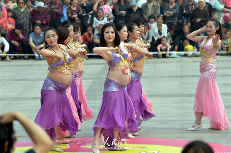 Pregnant women belly dance in street performance