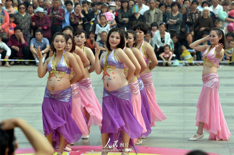 Pregnant women belly dance in street performance