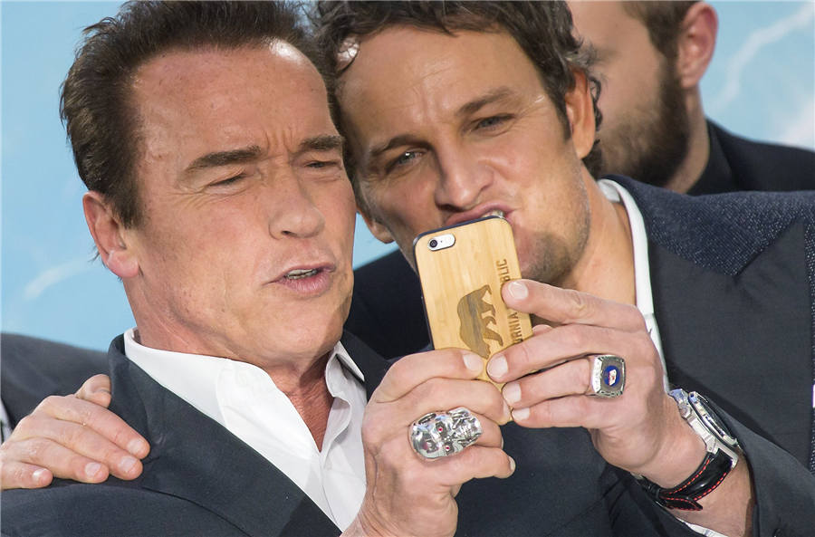 Arnold Schwarzenegger takes selfie with cast members in Berlin