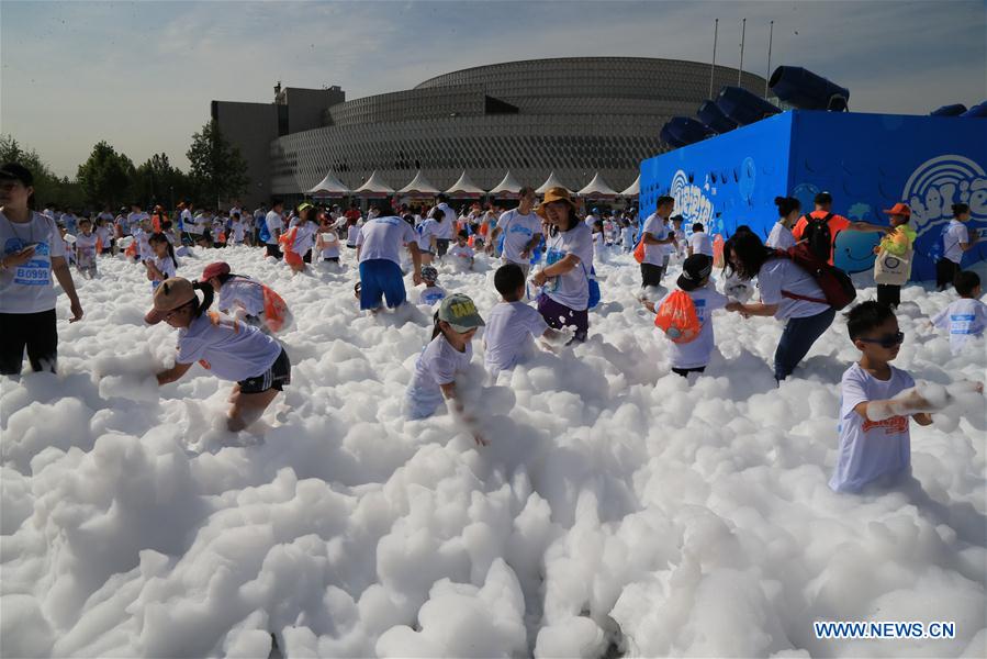 People take part in bubble run in Beijing