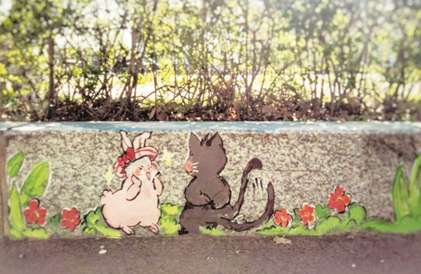 Cute graffiti decorate curbstones on campus