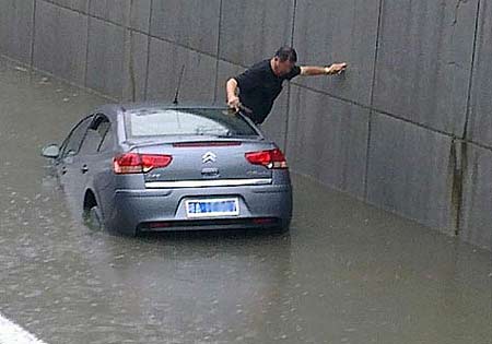 In a flash, car sinks in rainwater