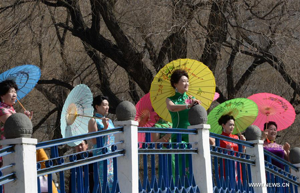 Women present cheongsam to mark coming International Women's Day in North China