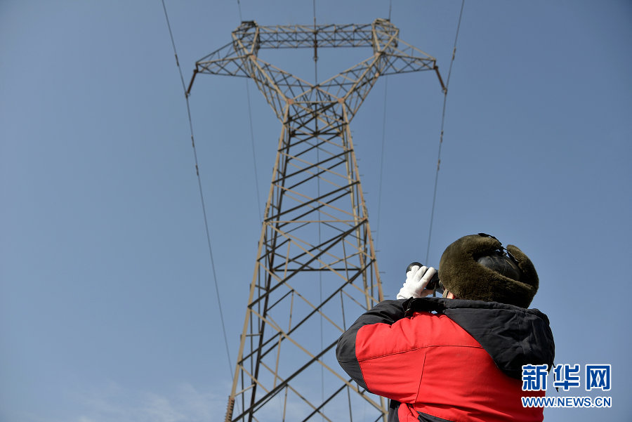 Electricians work on power lines in Wuhai