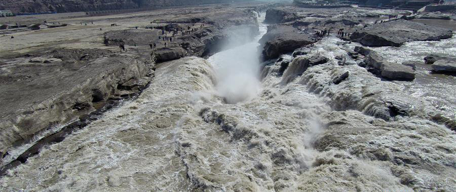 Surging water at Hukou Waterfall attracts tourists