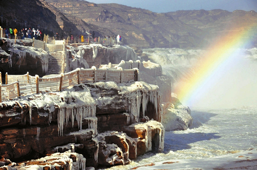 Rainbow arches over Hukou Waterfall on Yellow River