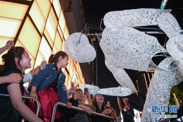Giant figure dances for Shenyang shoppers