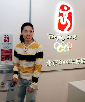 Athens swimming gold medallist Luo Xuejuan, who will be first Chinese Beijing Olympic torch relay runner, smiles during an interview in Beijing March 20, 2008. Luo is ready to leave for Olympia, Greece to carry the torch following the first torchbearer Alexandros Nikolaidis when the torch relay starts on March 24, 2008. [Xinhua]