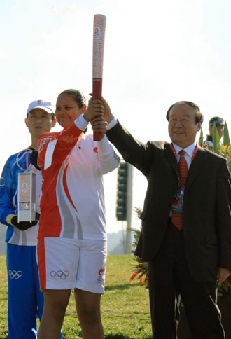 Tania Major (L), the young indigenous leader from Queensland, and Jiang Xiaoyu, Executive Vice President of the Beijing Organizing Committee for the Games, hold the Beijing Olympic torch before running the opening leg of the torch relay in Canberra, Australia, April 24, 2008. Eighty torch runners will run through the 16-km routes which started from the Reconciliation Place in front of the old parliament house and will end at the Stage 88 in the Commonwealth Park. [Xinhua]