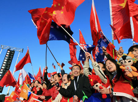 Overseas Chinese supporters wave Chinese national flags during the openning ceremony for the Beijing Olympic torch relay in Canberra, Australia, April 24, 2008. [Xinhua]