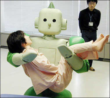 The RI-MAN robot carries a life-sized doll at the Riken laboratory in Nagoya, central Japan. The RI-MAN is a seeing, hearing and smelling robot that can carry human beings and is aimed at helping care for the country's growing number of elderly.(AFP/JIJI PRESS) 