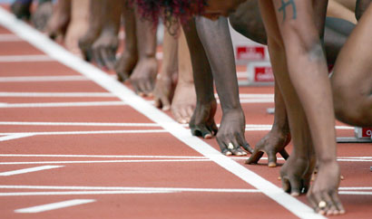 Athletes line up for the 100m women's heats during the Commonwealth Games at the Melbourne Cricket Ground in Melbourne March 19, 2006. 
