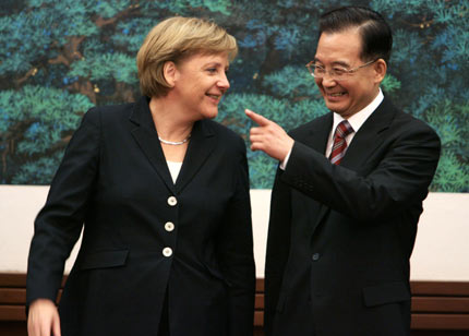 Chinese Premier Wen Jiabao (R) speaks to German Chancellor Angela Merkel after their meeting at the Great Hall of the People in Beijing May 22, 2006. China and Germany signed a batch of 19 agreements on the first day of Merkel's visit, including to build a high-speed rail system. [Reuters]