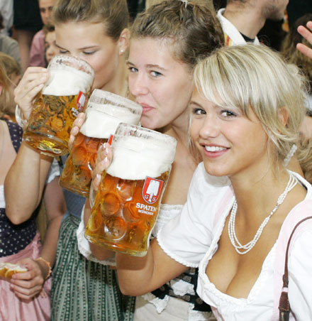 Young women in traditional Bavarian clothes toast with one-litre beer mugs during the opening day of the Oktoberfest in Munich in this September 17, 2005 file photo. The FIFA soccer World Cup 2006 final will be held in Germany from June 9 - July 9. 