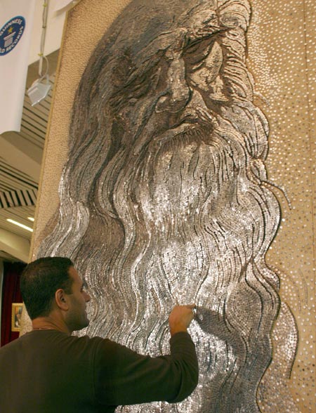 A man looks at the portrait of Leonardo Da Vinci, created by artist Saimir Strati using industrial nails, at the International Centre of Culture in Tirana September 4, 2006. Strati, 40, was recognised by Guinness World Record officials for having created the world's largest nail mosaic, which consisted of about 500,000 industrial nails on a 8 square-meter wooden board.