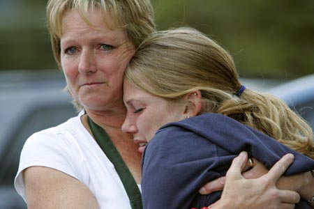Jean Hasse (L) hugs her daughter Kelly after they were reunited after Kelly was released from the Platte Canyon High School in Bailey, Colorado, September 27, 2006 after shots were fired at the school and hostages taken. 