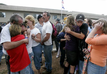 Families embrace after being reunited when their children were released from the Platte Canyon High School in Bailey, Colorado, September 27, 2006, after shots were fired at the school and hostages taken. 