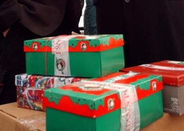 Gift boxes are seen in New York in a 2002 file photo. Wrapping up that unwanted picture frame from last Christmas and giving it to someone else as a gift might not be as taboo as it once was, according to a study released on Wednesday.