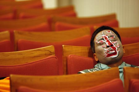 A Chinese artist takes a nap before performing in an English version of the traditional Chinese opera Monkey King at a theatre in Shanghai December 8, 2006. Among the performers is Ghaffar Pourazar of Britain (not in photo), the first foreigner to complete the rigorous training at the Beijing Opera School and the National Academy. He is performing with Chinese artists from the International Centre for Beijing Opera, and other troupes, at their first show in Shanghai. 