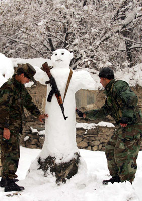 Two soliders make a snowman after a heavy snow fall in Kabul, Afghanistan December 26, 2006.