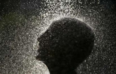 A young Hindu devotee takes a shower before starting his pilgrimage to the sacred Batu Caves temple during Thaipusam festival in Kuala Lumpur on January 31, 2007. Thousands of Hindus, who comprise over eight percent of the 26 million Malaysia's population, participate in the annual Hindu thanksgiving festival, in which devotees subject themselves to painful rituals in a demonstration of faith and penance, held in honour of Lord Subramaniam. REUTERS/Bazuki Muhammad (MALAYSIA)