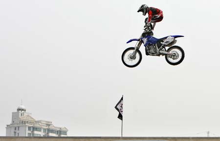 Chucky Norris of Australia jumps with his motorcycle during a demonstration performance on the opening day of Asia Extreme Games in Shanghai May 3, 2007.