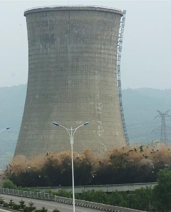 A cooling tower at the HunJiang Power Generation Company is imploded in Baishan,Northeast China's Jilin Province, July 6, 2007. China pledged to cut greenhouse gas emissions as it unveiled its first climate change action plan in early June. China has closed down small thermal power plants with total power generating capacity of 5.5 million kilowatts by now, completing 55 percent of the country's goal for this year, Xinhua reported.