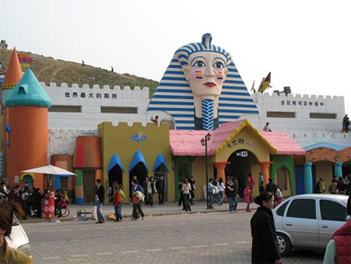 People walks past a public toilet in Southwest China's Chongqing Municipality, July 7, 2007. The disputed toilet features an Egyptian facade, soothing music and more than 1,000 toilets spread out over 30,000 square feet.[www.xinhuanet.com] 