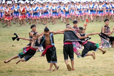 Ethnic Miao performers dance during the opening ceremony of Kaili Original Ethnic Culture & Arts Festival in Kaili, Qiandongnan Miao-Dong Autonomous Prefecture, Southwest China's Guizhou Province, July 23, 2007. There are 47 nationalities, such as the Miao, Dong, and Buyi, in Qiandongnan, making it the prefecture with the largest number and highest proportion of the ethnic-minority population in China.[newsphoto]