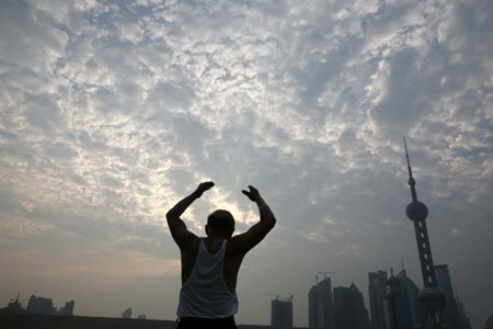 A man does his morning exercise at the Bund on the banks of the Huangpu River in Shanghai August 6, 2007. The Bund is one of the most famous tourist sites in Shanghai. Locals use the Bund as a place for morning exercises as well as other activities. 