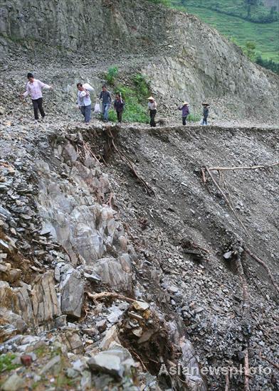 Villagers rebuild sole road after flood