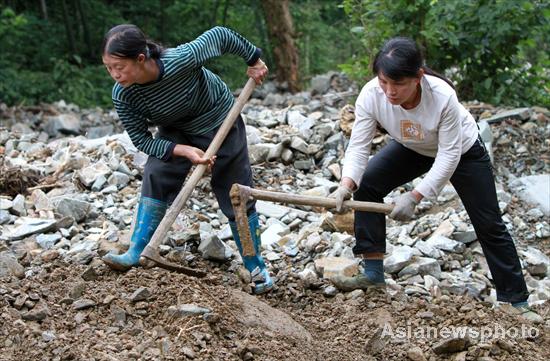 Villagers rebuild sole road after flood