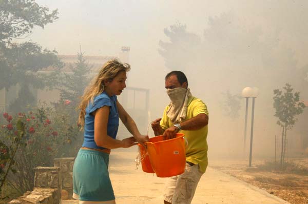 Wildfires rage in Athens suburbs, causing property damage