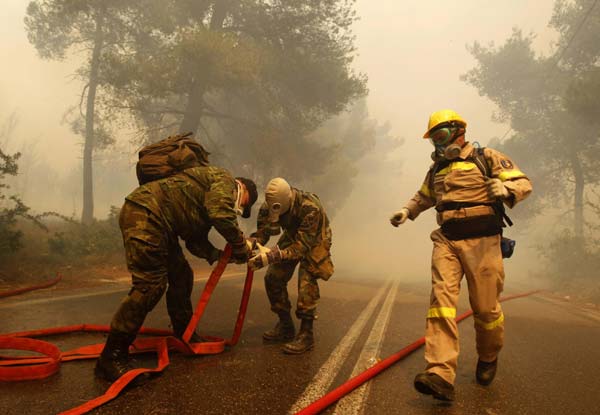 Wildfires rage in Athens suburbs, causing property damage