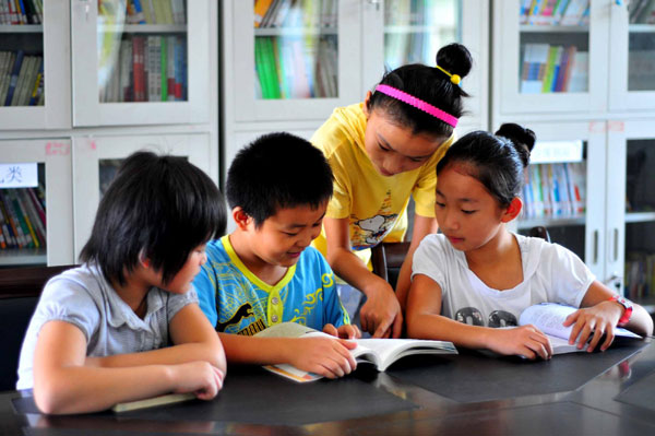 Left-behind children reading in village library