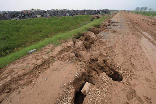 New dike suffers dozens of cave-ins after rain