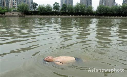 Swimmer jumps into river all tied up