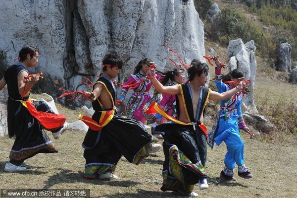 Yi folk artists perform ancient drama