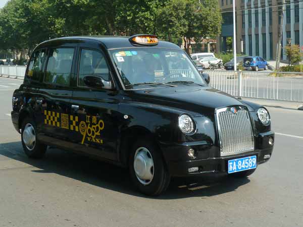 Classic British taxi cabs on road in E China