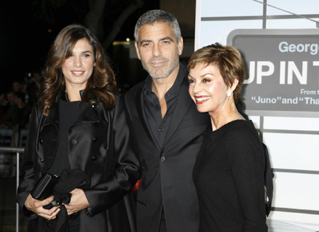 George Clooney and his girlfriend pose at the premiere of 