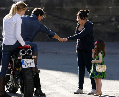 Tom Cruise holds Suri during a break in filming in Seville