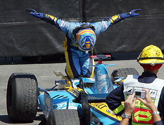Renault Formula One Driver Fernando Alonso of Spain kneels after winning the Canadian Formula One Grand Prix in Montreal June 25, 2006.